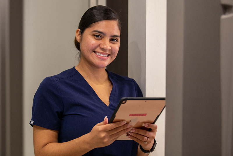 dental staff holding ipad tablet